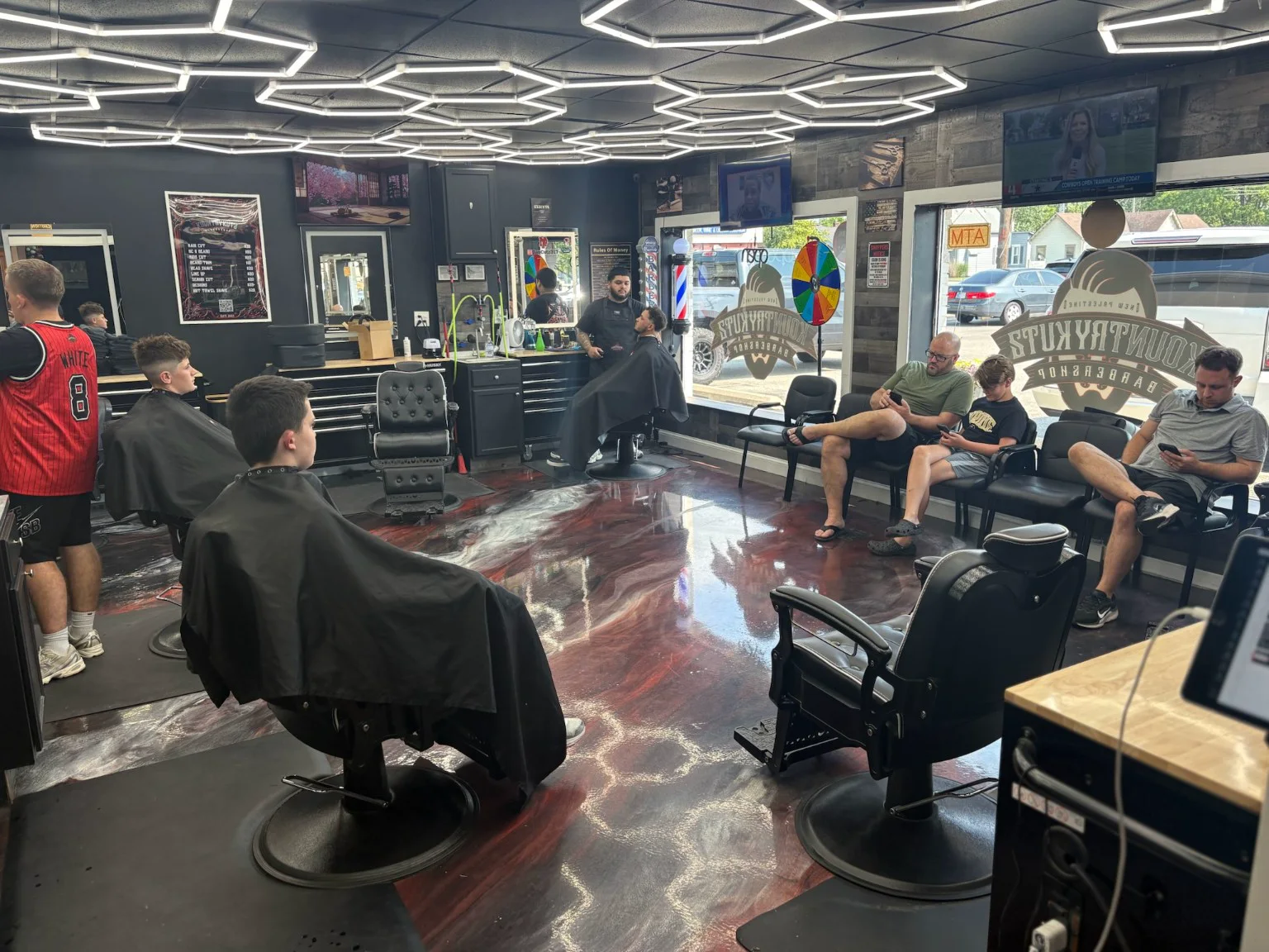 Barbers and customers inside Kountry Kutz apprenticeship host barbershop